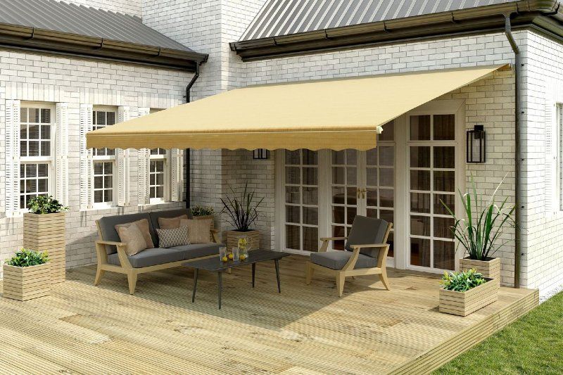 A patio with a canopy over it and a couch and chairs.
