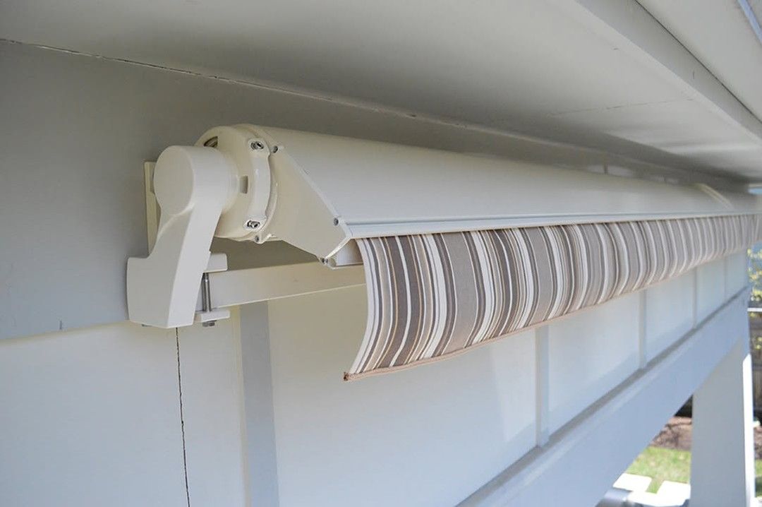 A white awning is hanging from the side of a building