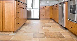 A kitchen with ceramic floor tile.