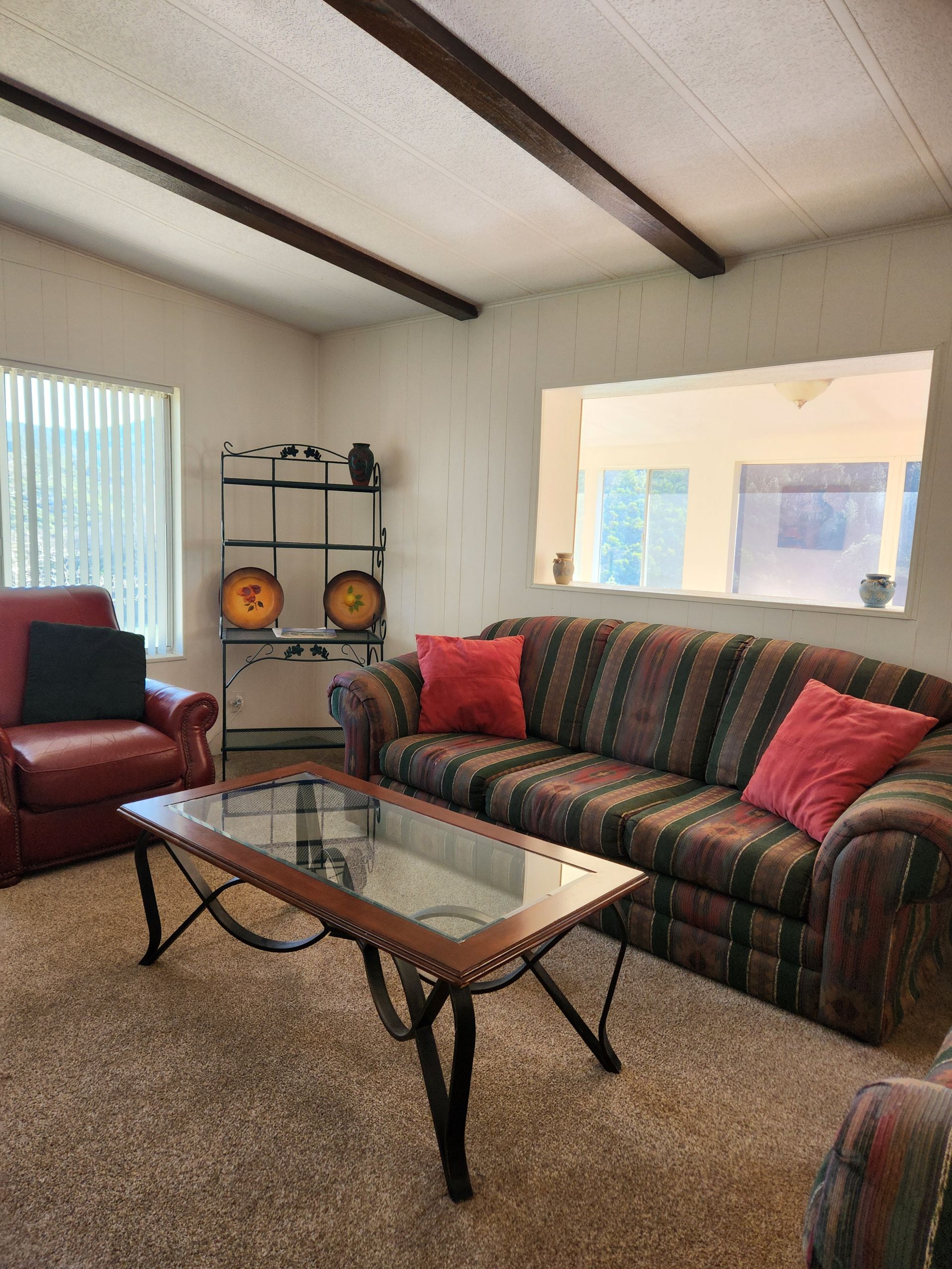 A living room with a couch, chair, and coffee table