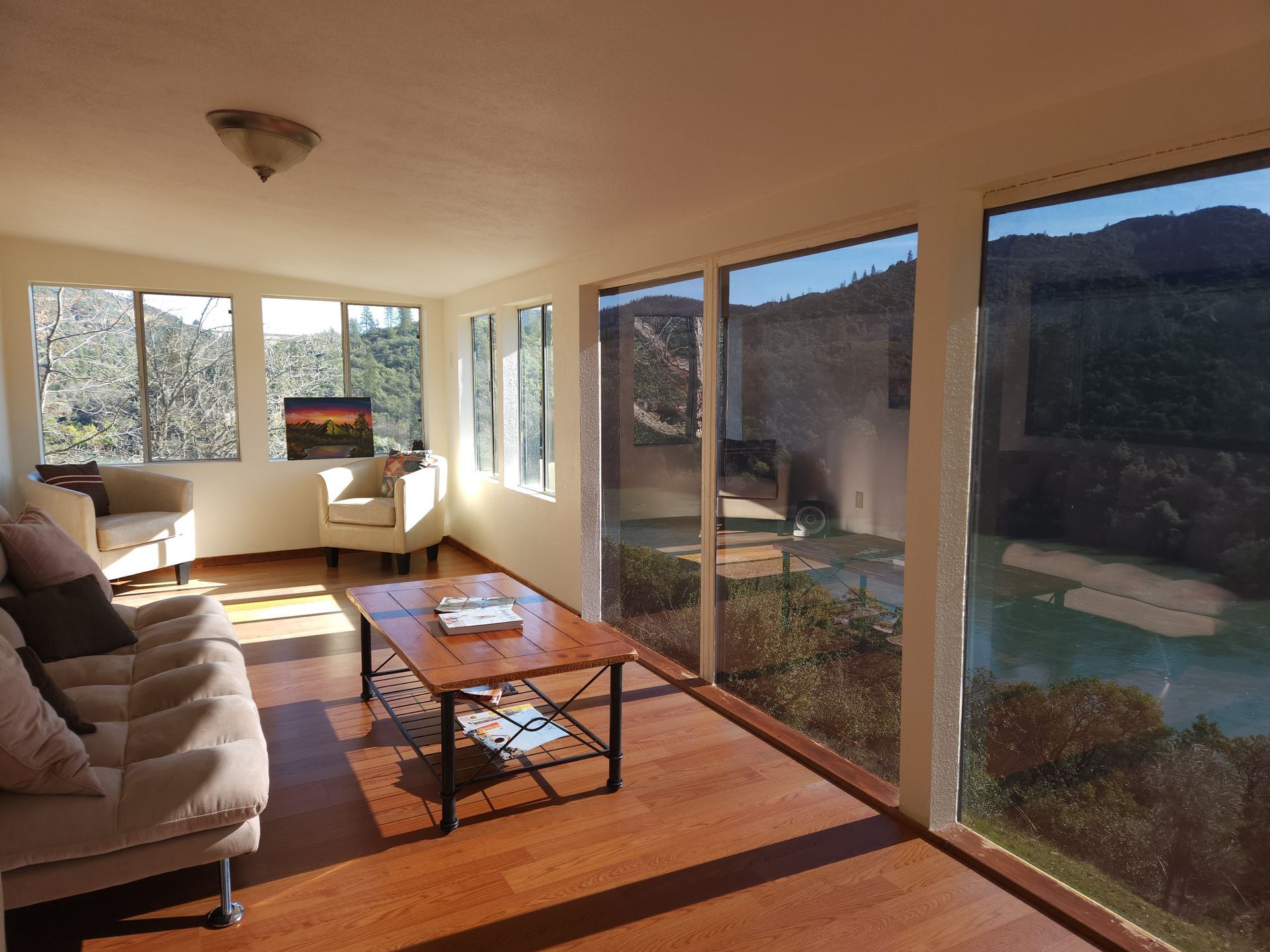 A sunroom with a couch and a coffee table