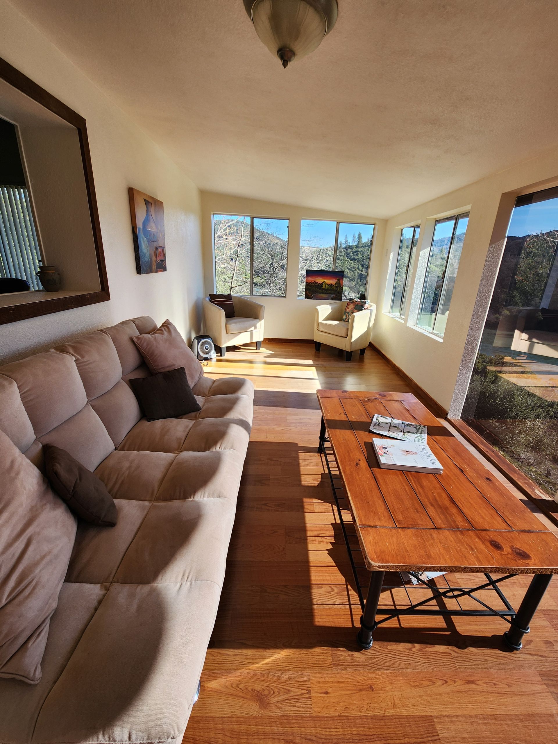 A sunroom with a couch and a coffee table