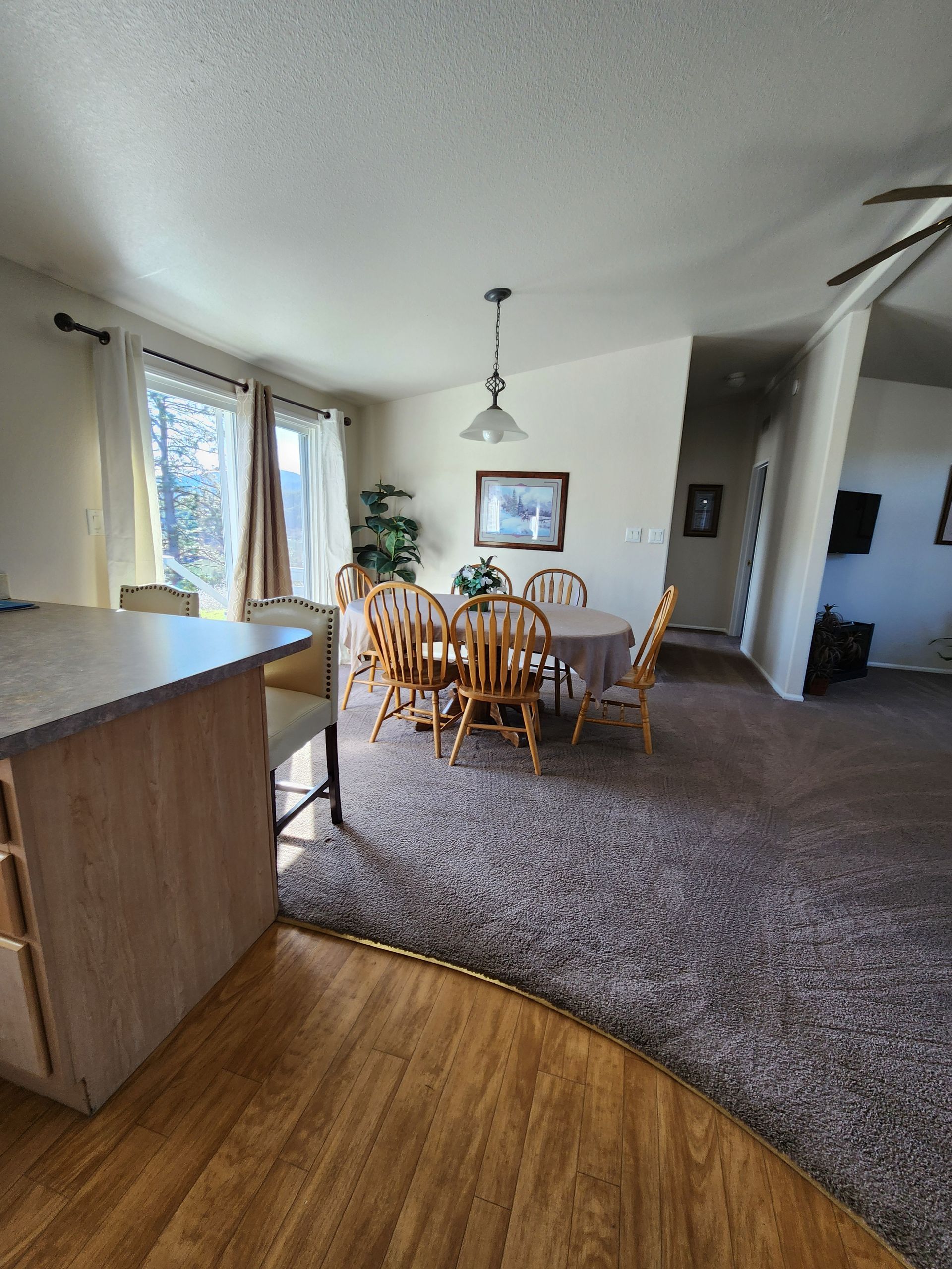 A dining room with a table and chairs in a mobile home.