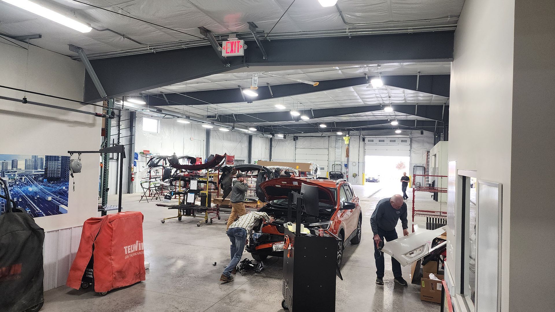 A man is working on a car in a garage.