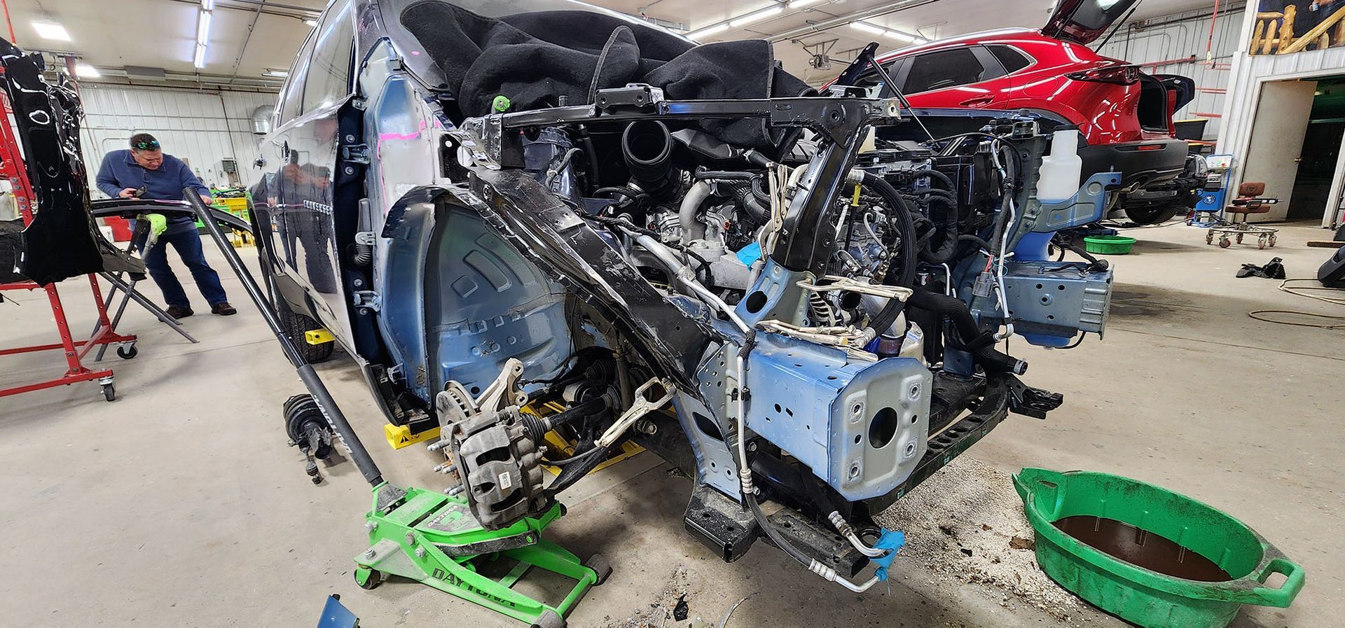 A helicopter is being dismantled in a garage.