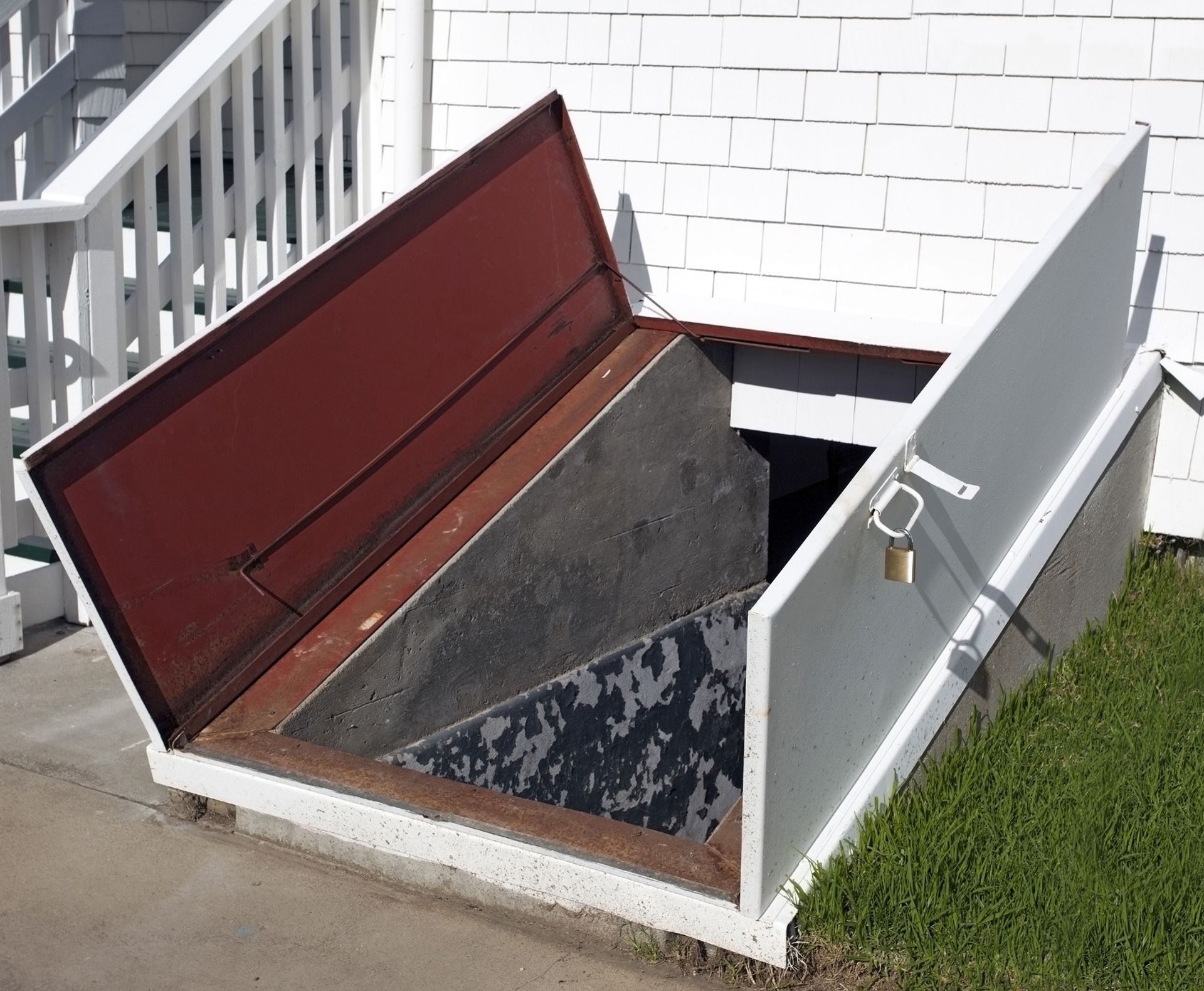 Opened metal cellar doors outside a house