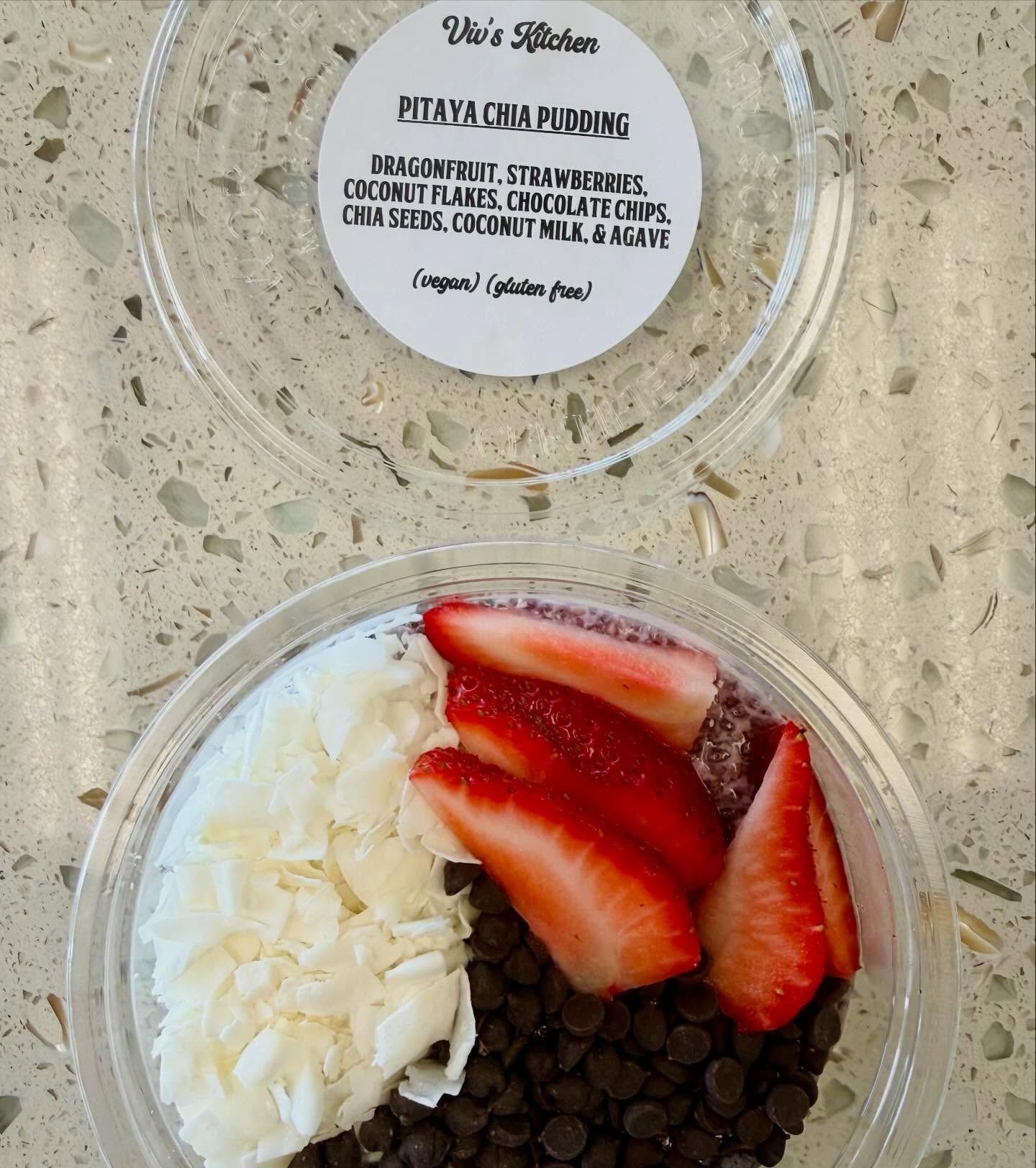 Chia pudding with strawberries, coconut flakes, and chocolate chips in a plastic container.