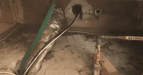 View of a basement ceiling with ductwork, electrical cables, and a gas pipe labeled 