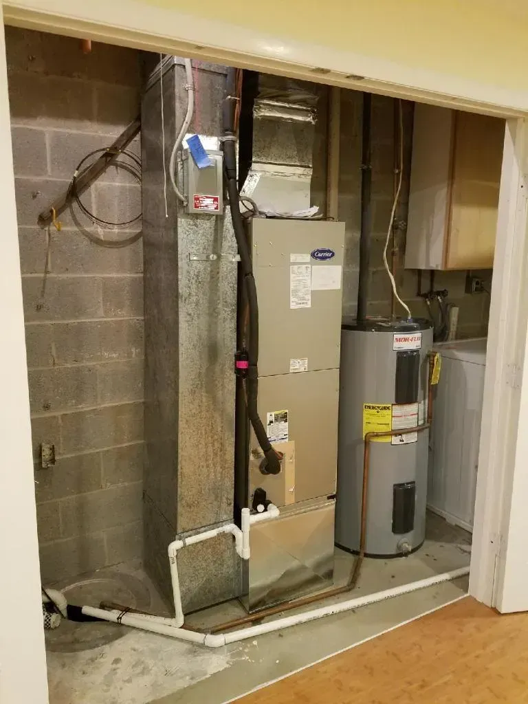 HVAC equipment in a basement, including a furnace, ductwork, water heater, and washing machine.