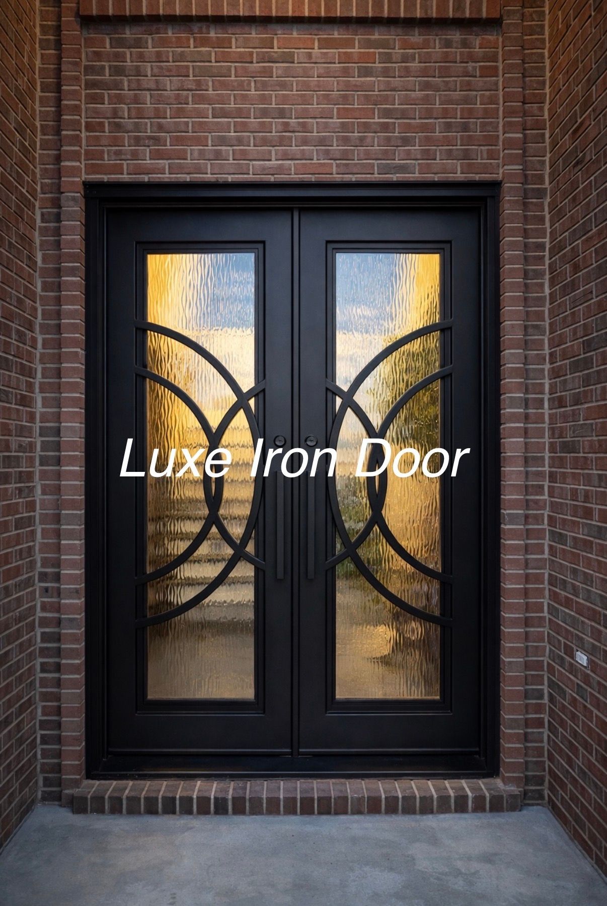 Black iron double front door with decorative curved metalwork in a brick entryway