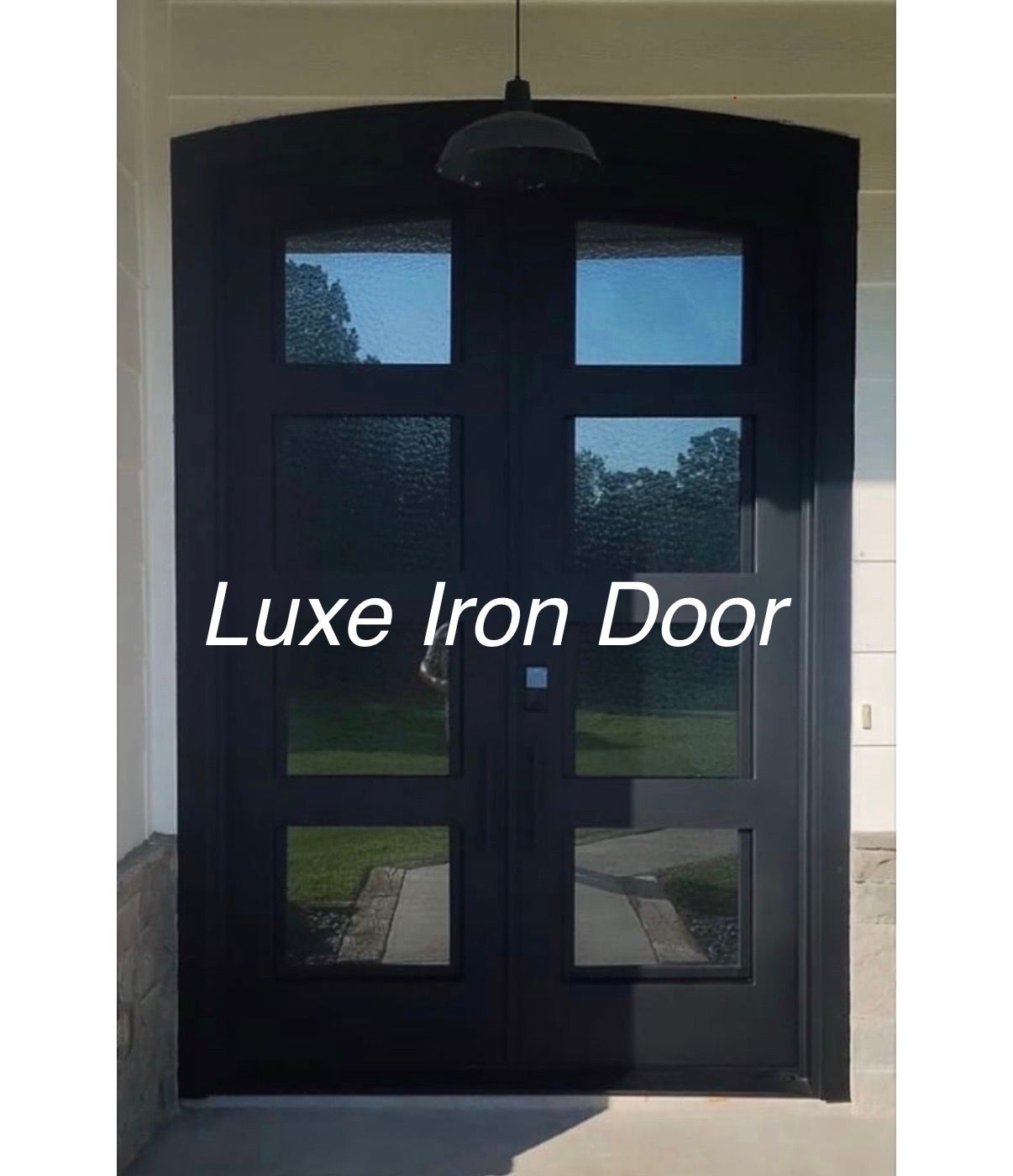 Black iron double front door with glass panes and a hanging light above
