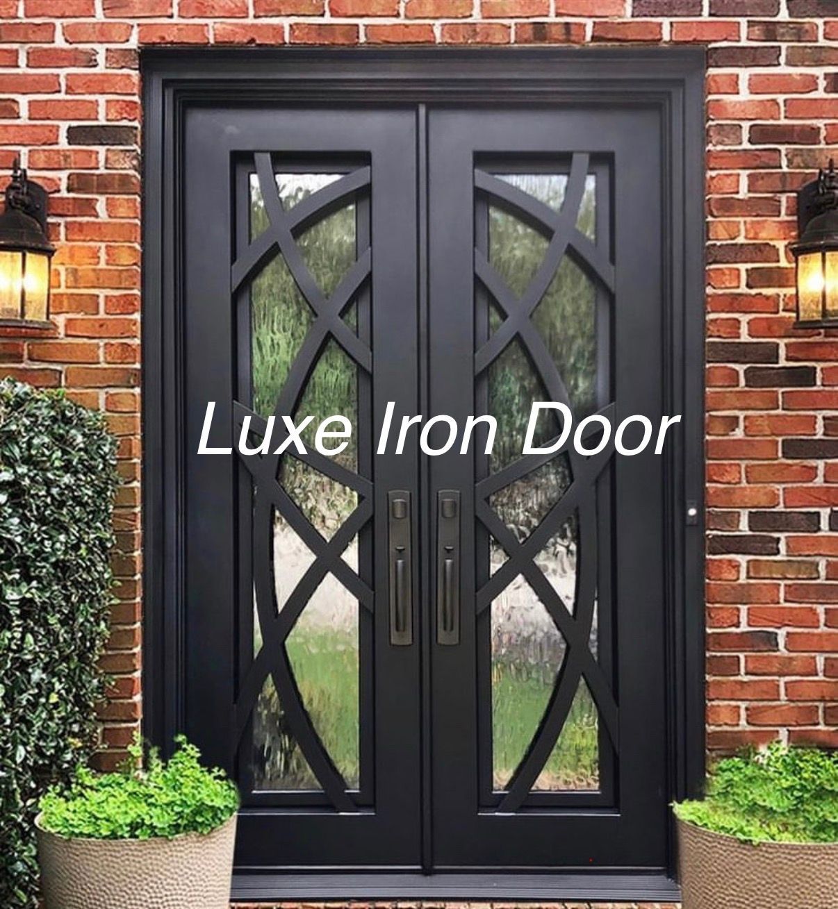 Black iron double front door with glass panels and X lattice, set in a brick entryway