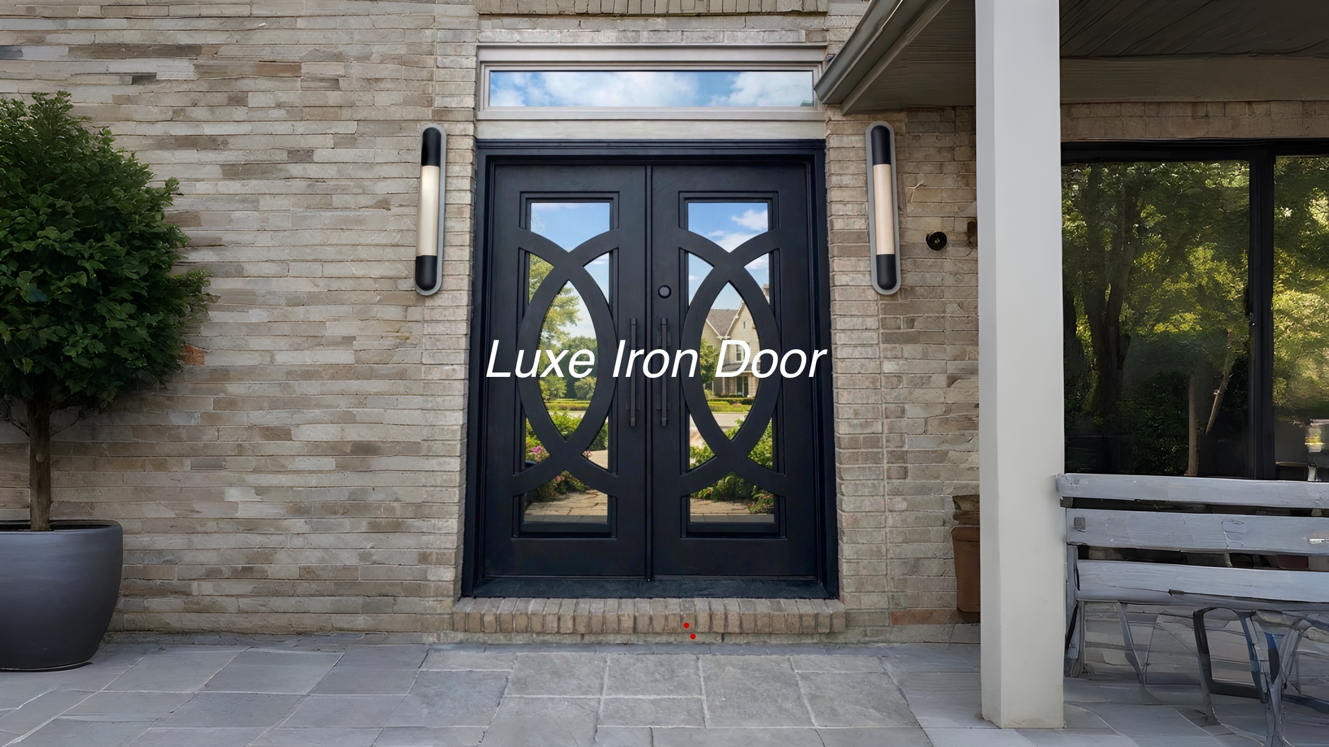 A black double iron door with oval patterns on a textured stone home exterior, featuring a glass transom and wall lights.
