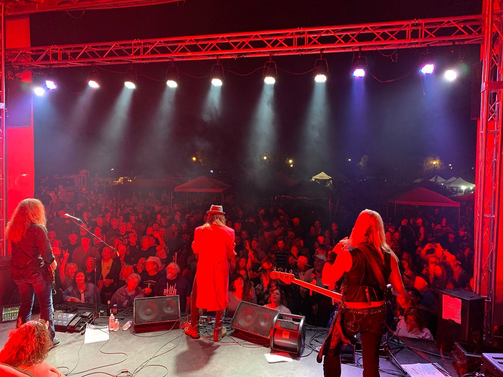 A group of people are standing on a stage in front of a crowd