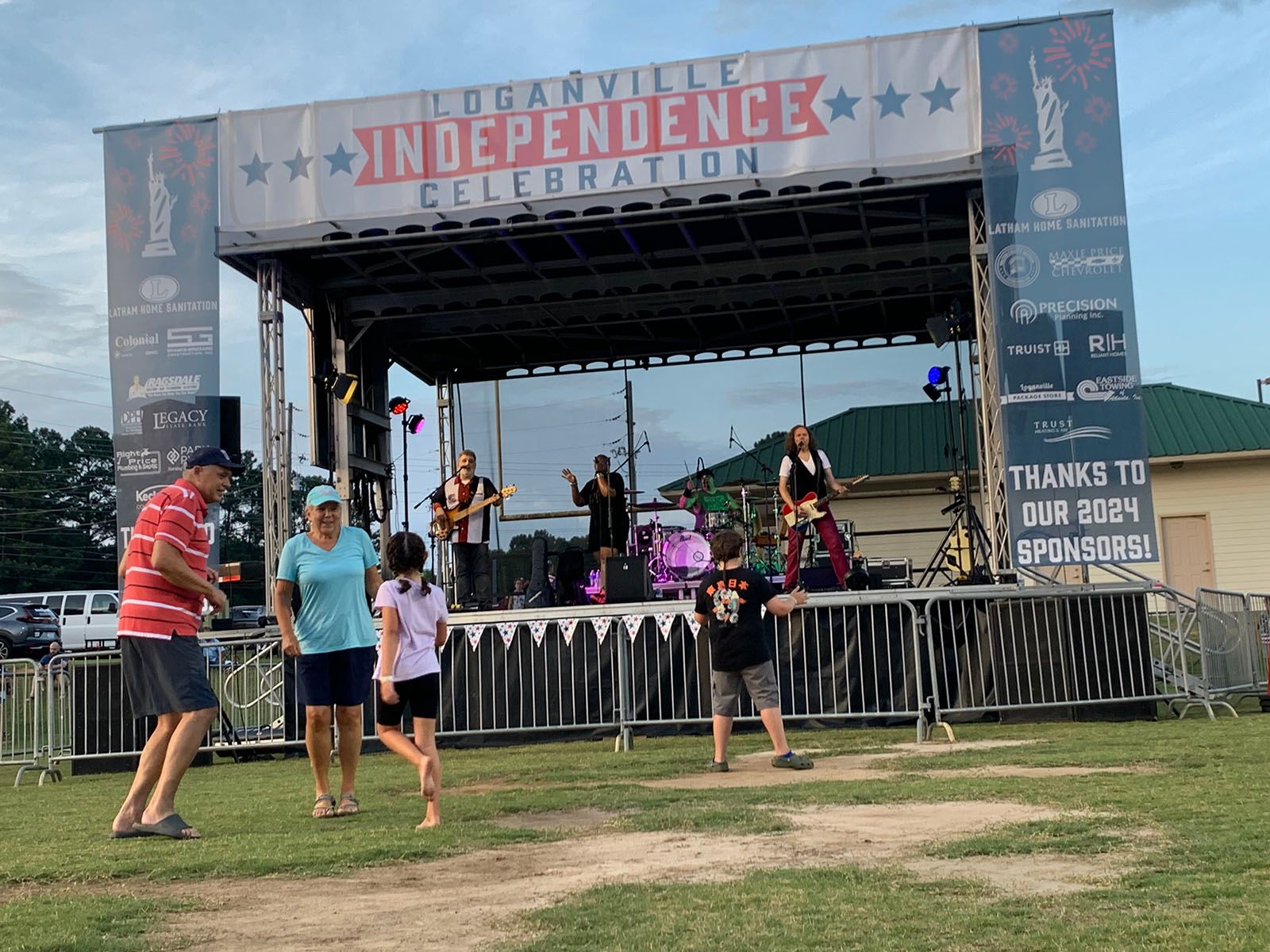 A group of people standing in front of a stage