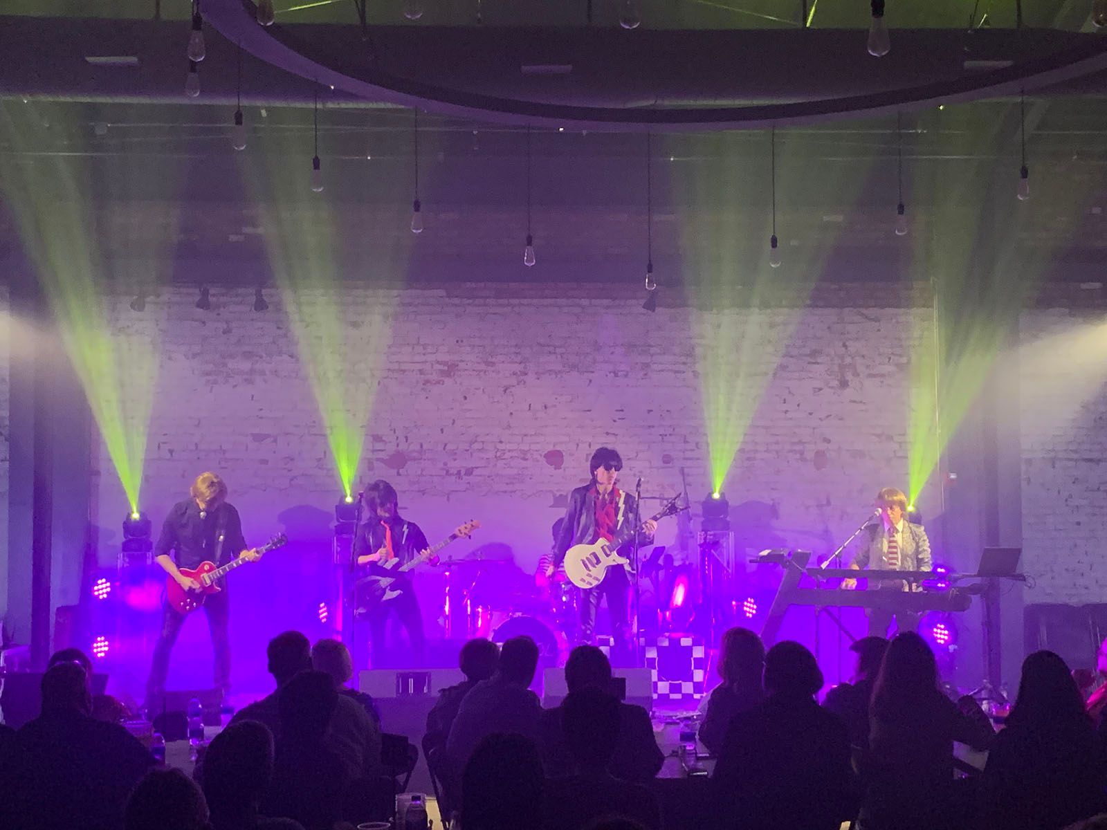 A band is playing a concert in front of a crowd