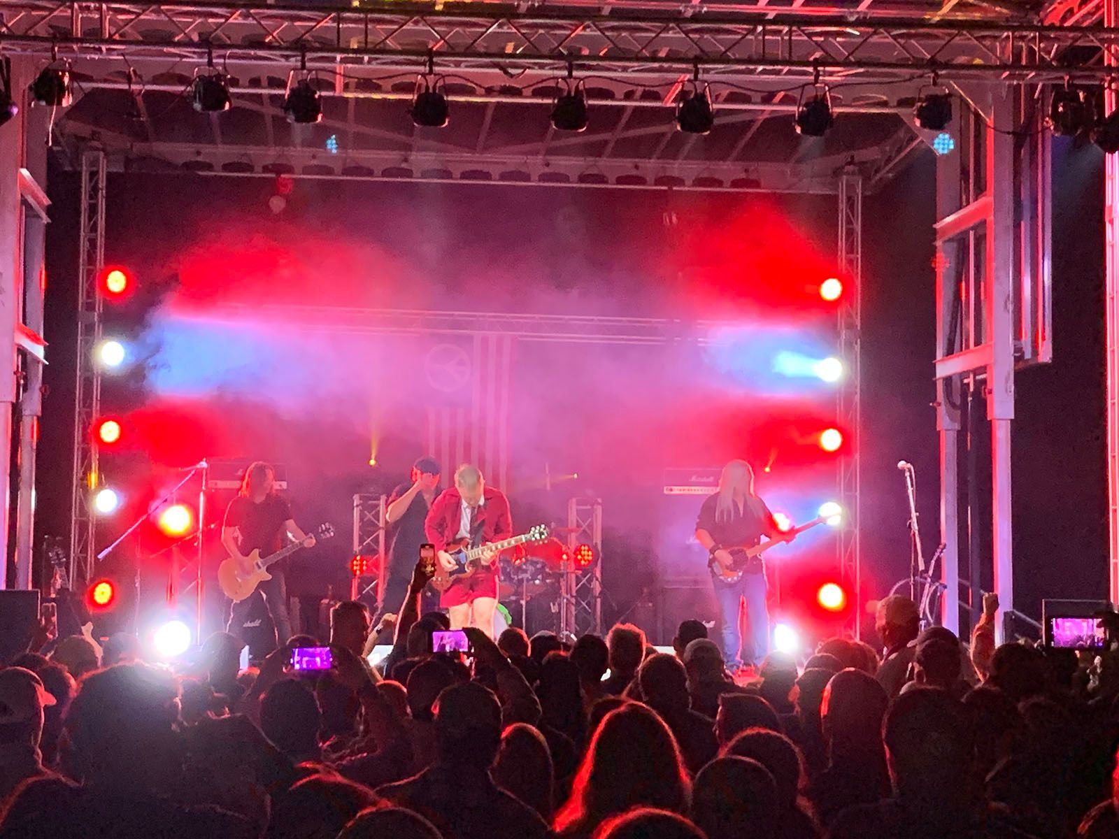 A band is performing on stage in front of a crowd