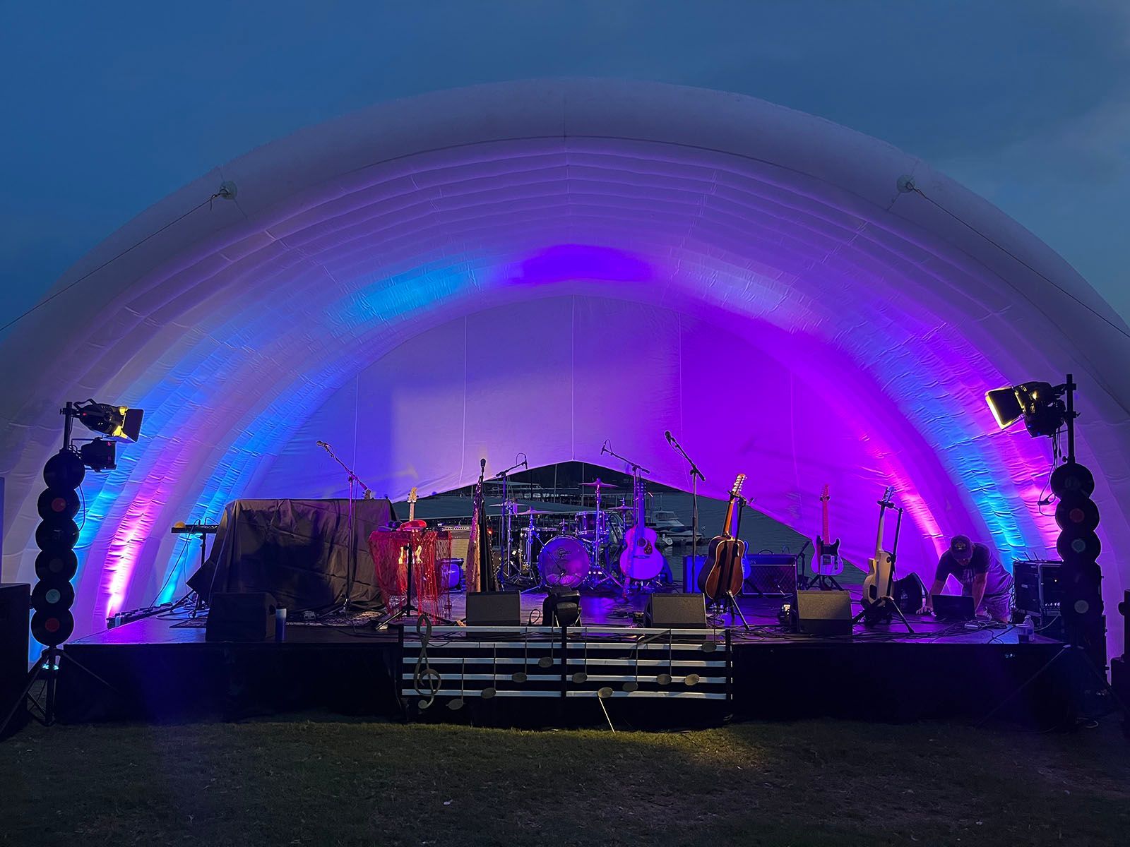 A stage is lit up with purple and blue lights