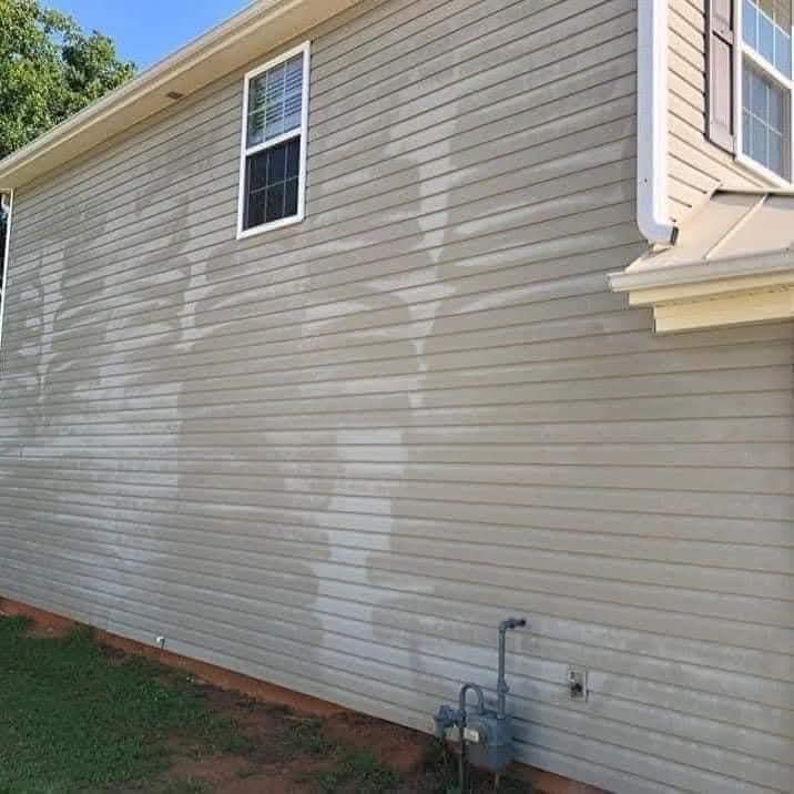 House siding with water stains and a gas meter on the side wall