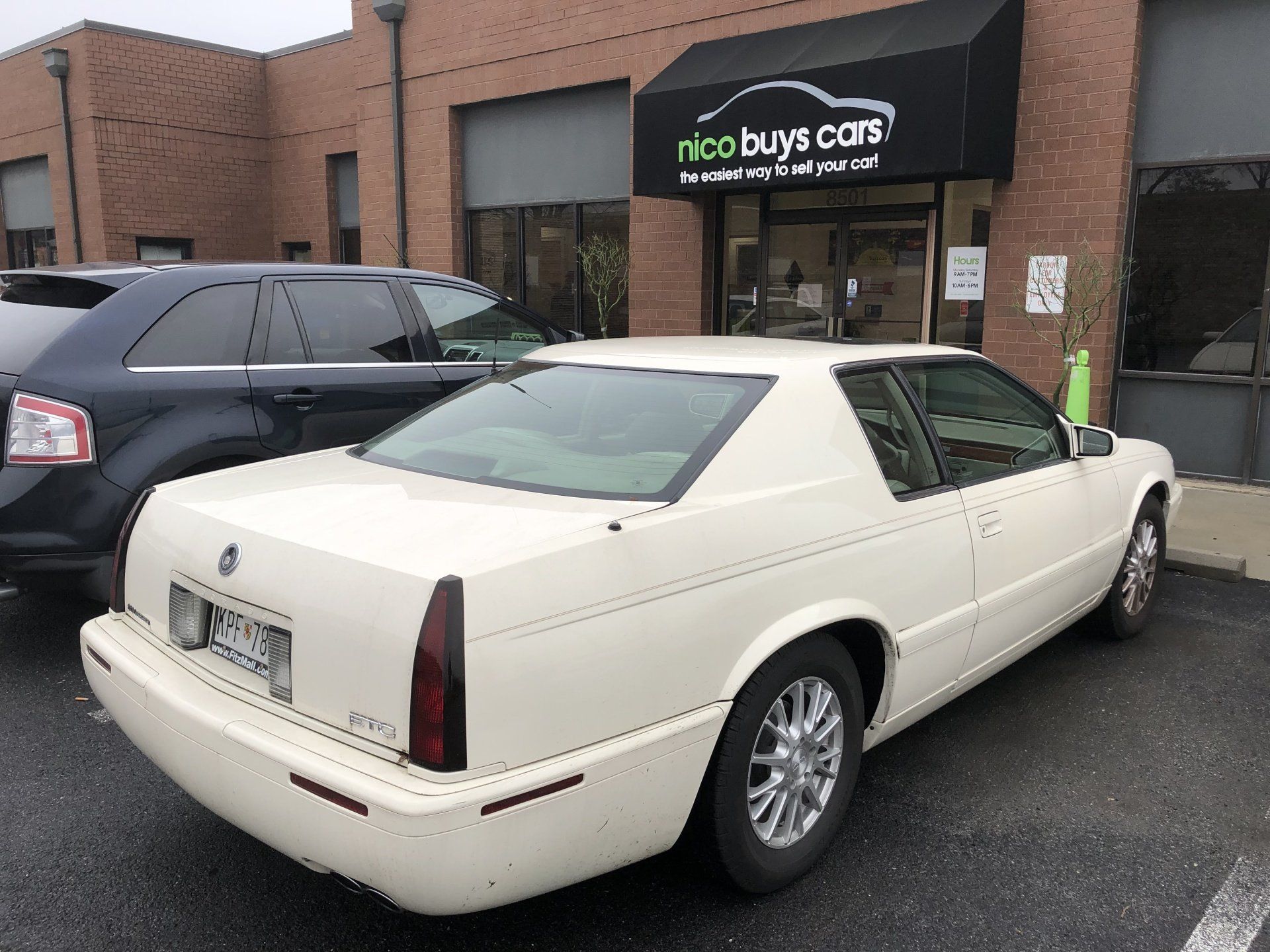 White Cadillac Eldorado Parked Front of Nico Buys Cars