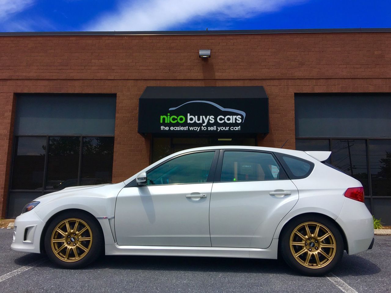 White Car Parked Front of Nico Buys Cars