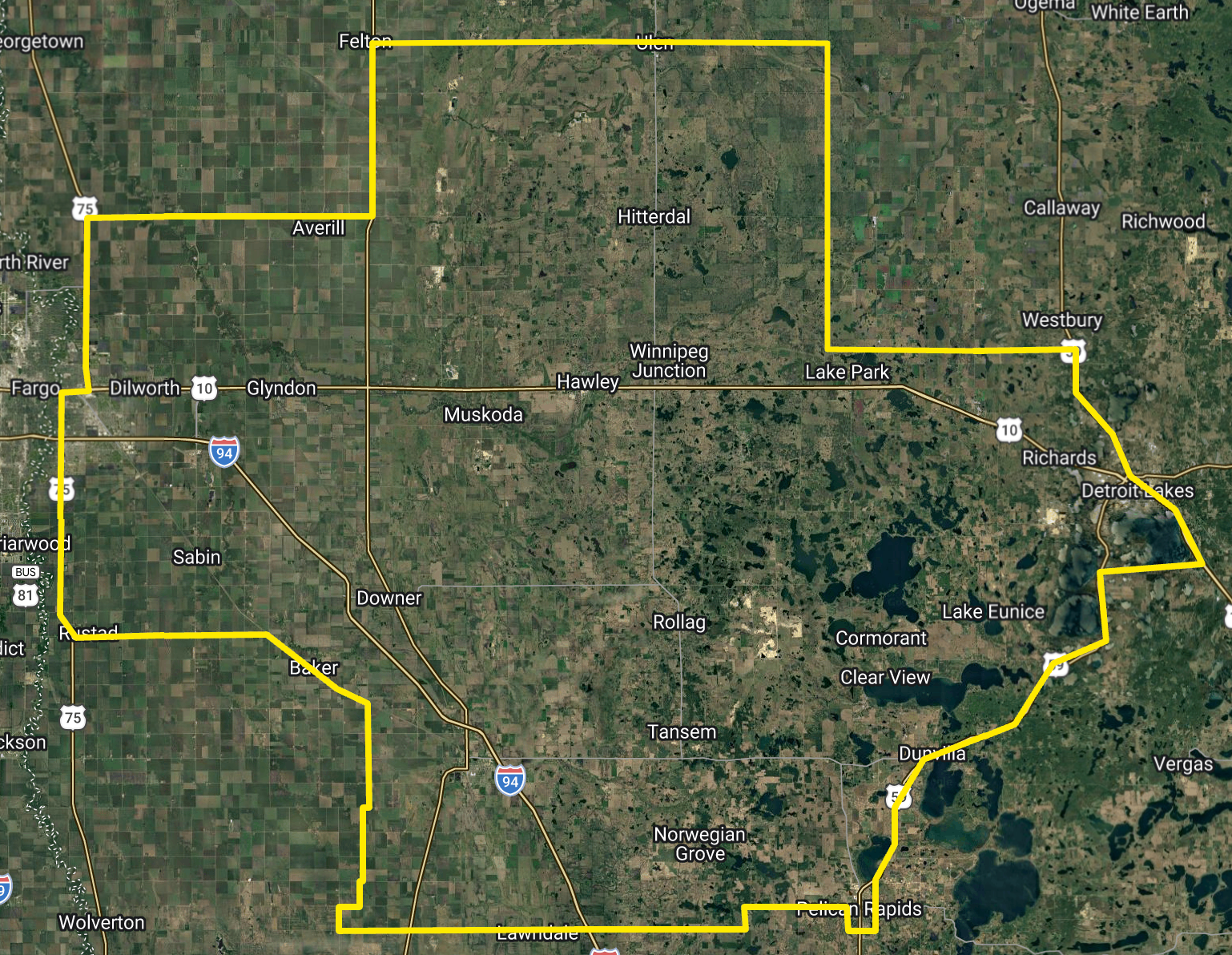 Satellite map with a yellow outlined boundary around a rural area and roads.