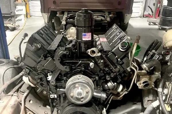 A car engine is being worked on in a garage.