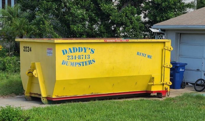 Residential garage cleanout using a driveway-safe dumpster for a New Year home organization project