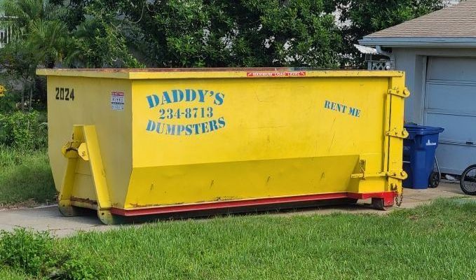 Roll-off dumpster in driveway for pre-storm debris removal in Sarasota, FL