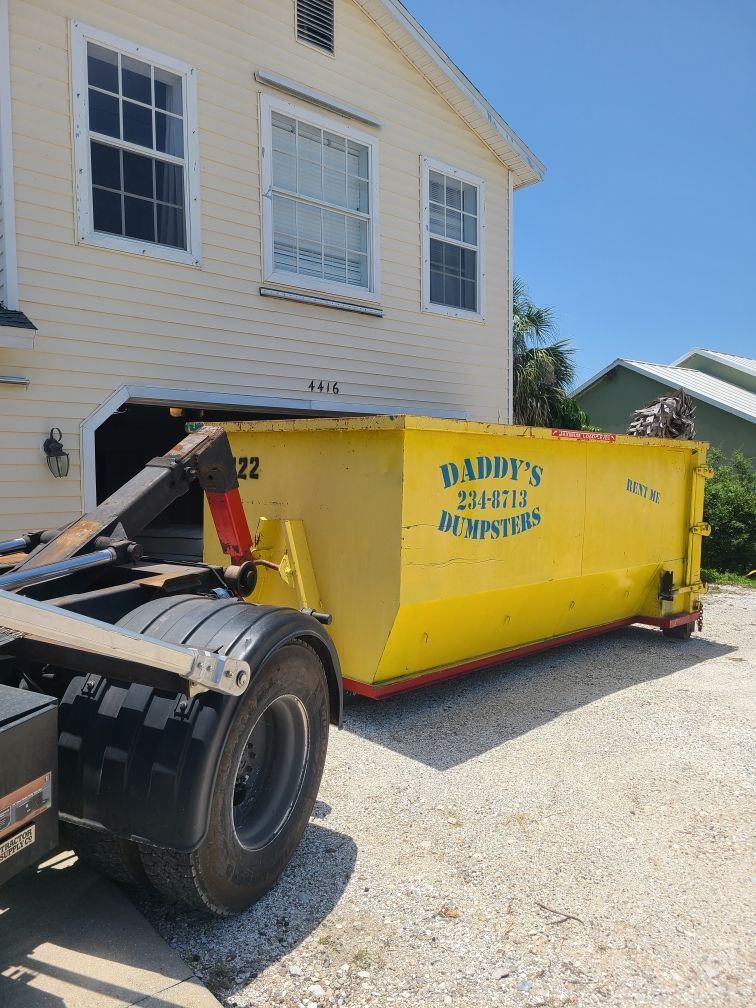 Roll-off dumpster in driveway for pre-storm debris removal in Sarasota, FL
