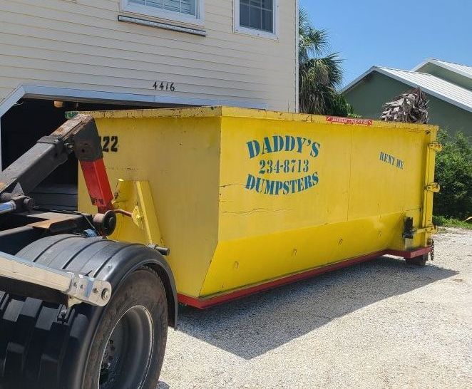 Daddy’s Dumpsters 20-yard dumpster placed on plywood in a North Port, FL driveway—protecting pavement while handling debris from a home renovation project.