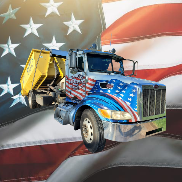 American flag-themed truck with yellow dumpster, patriotic graphics.