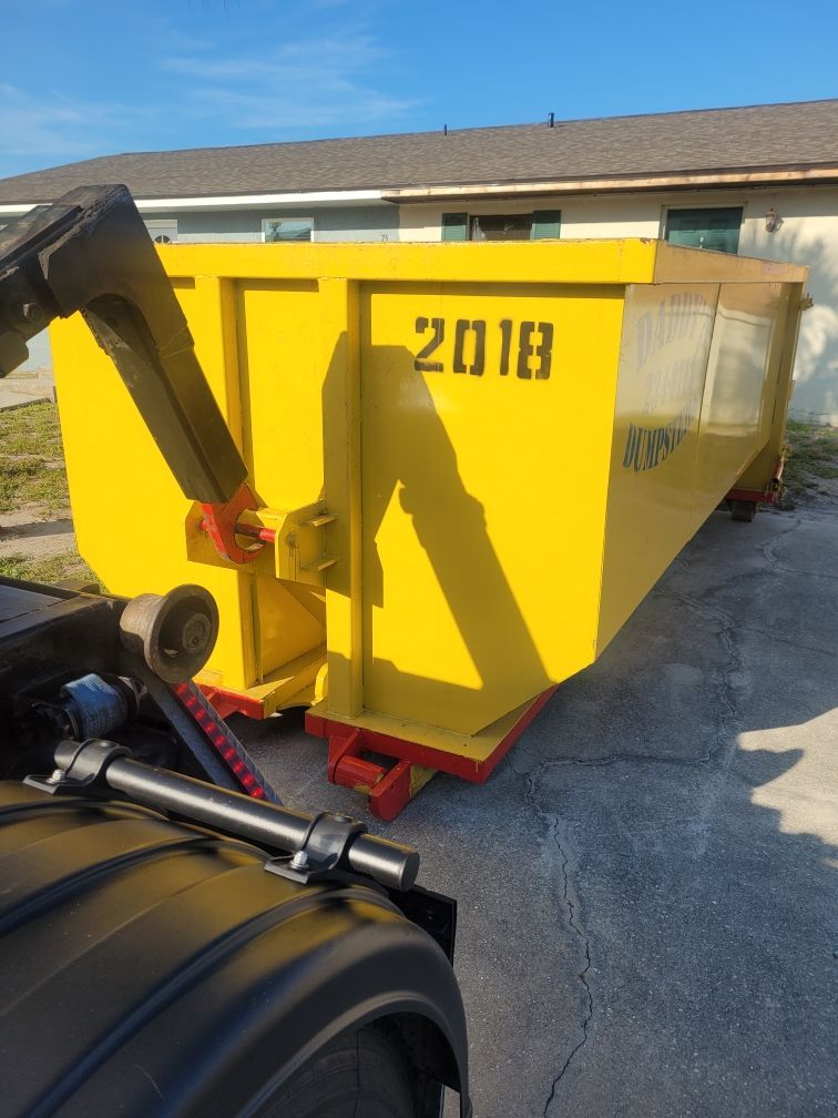 A yellow dumpster with the year 2018 on it. Roll-Off Dumpster Rental in Sarasota.