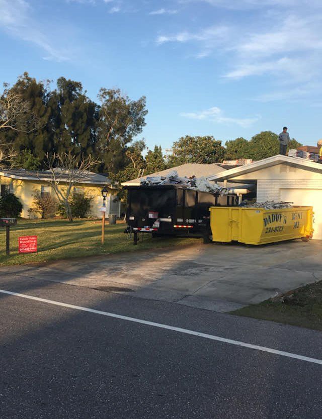 A dumpster is in front of a house. Roll-Off Dumpster Rental in Sarasota.