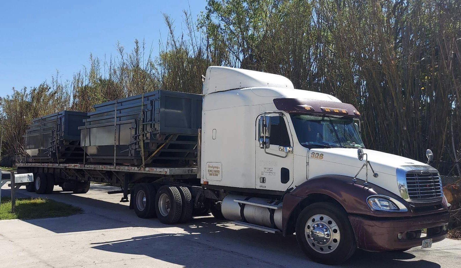 A semi-truck is parked on the side of the road. Roll-Off Dumpster Rental in Sarasota.