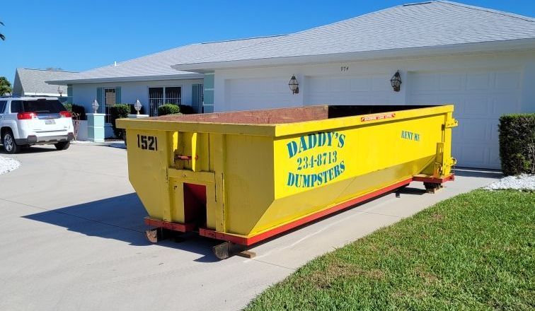 15-yard roll-off dumpster placed in a residential driveway for a home cleanout in Manatee County, Florida