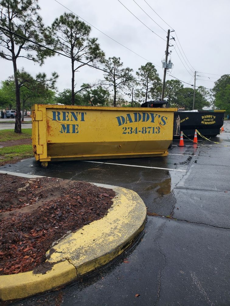 A yellow dumpster that says Rent Me on it. Roll-Off Dumpster Rental in Sarasota.