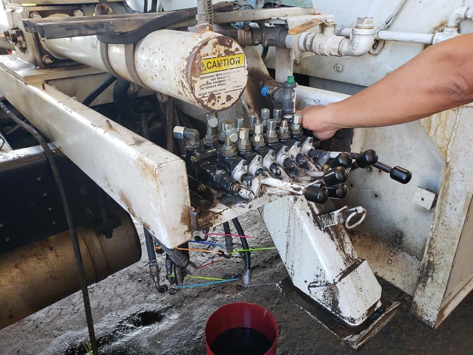 A person is working on a machine that says caution on it