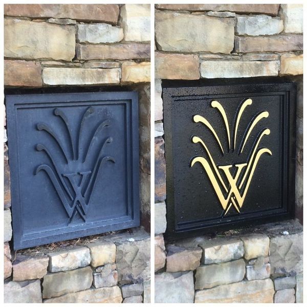 Two images side by side: a dark gray emblem and a black emblem with gold accents; both are set into a stone wall.