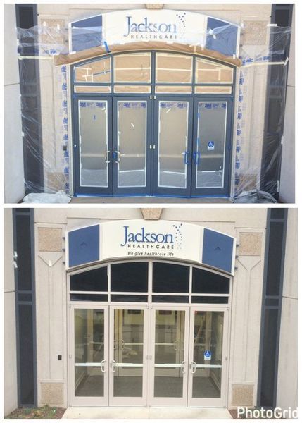 Top and bottom views of a building entrance before and after renovations. The new doors are light-colored. The upper doors are a dark blue.