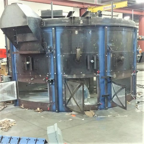 Large industrial oven, dark metal with blue frame, multiple doors and openings.