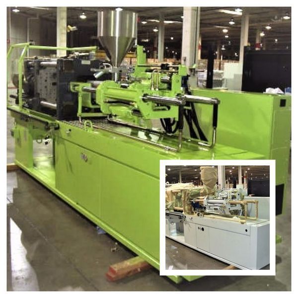 Green injection molding machine in a factory setting.