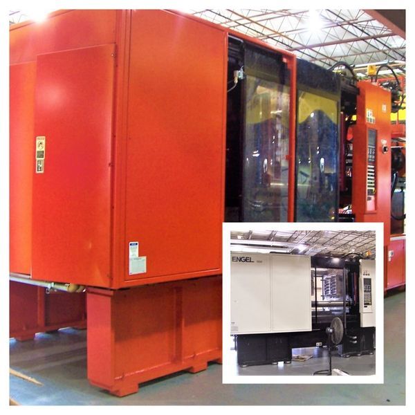 Large red industrial molding machine in a factory setting.
