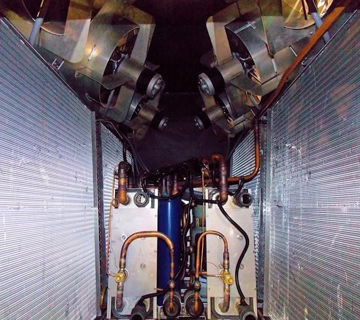 The inside of a machine with pipes and fans