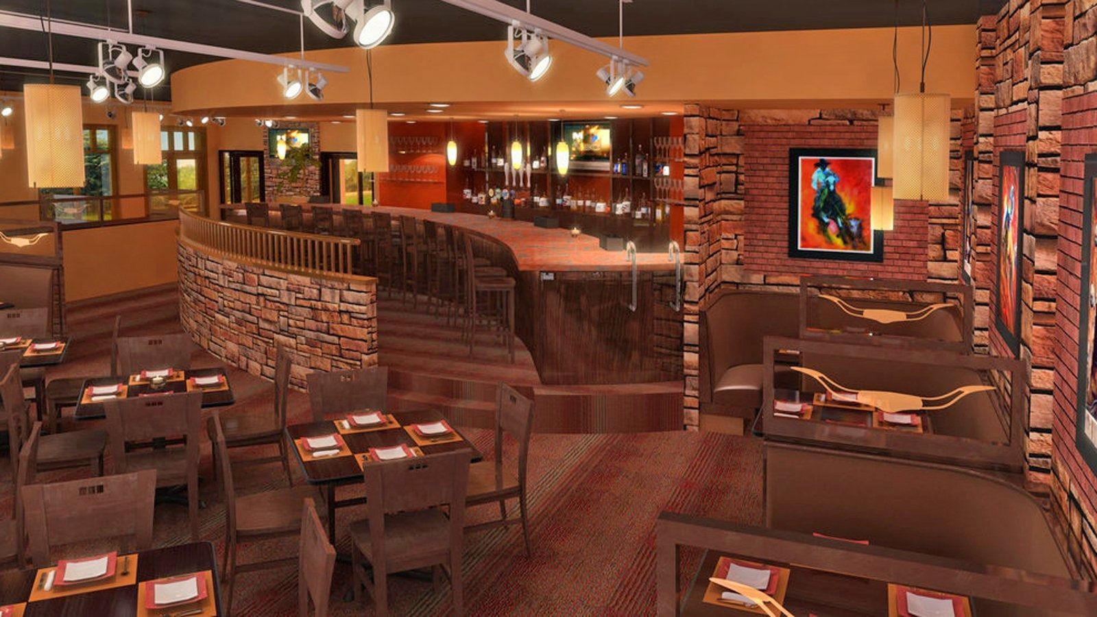 Warm-lit restaurant interior with brick walls, wooden tables, booths, and framed art throughout.