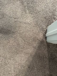 repaired carpet near a white door frame