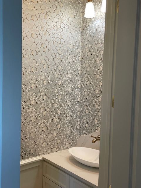 A beautiful bathroom sink with gold faucet