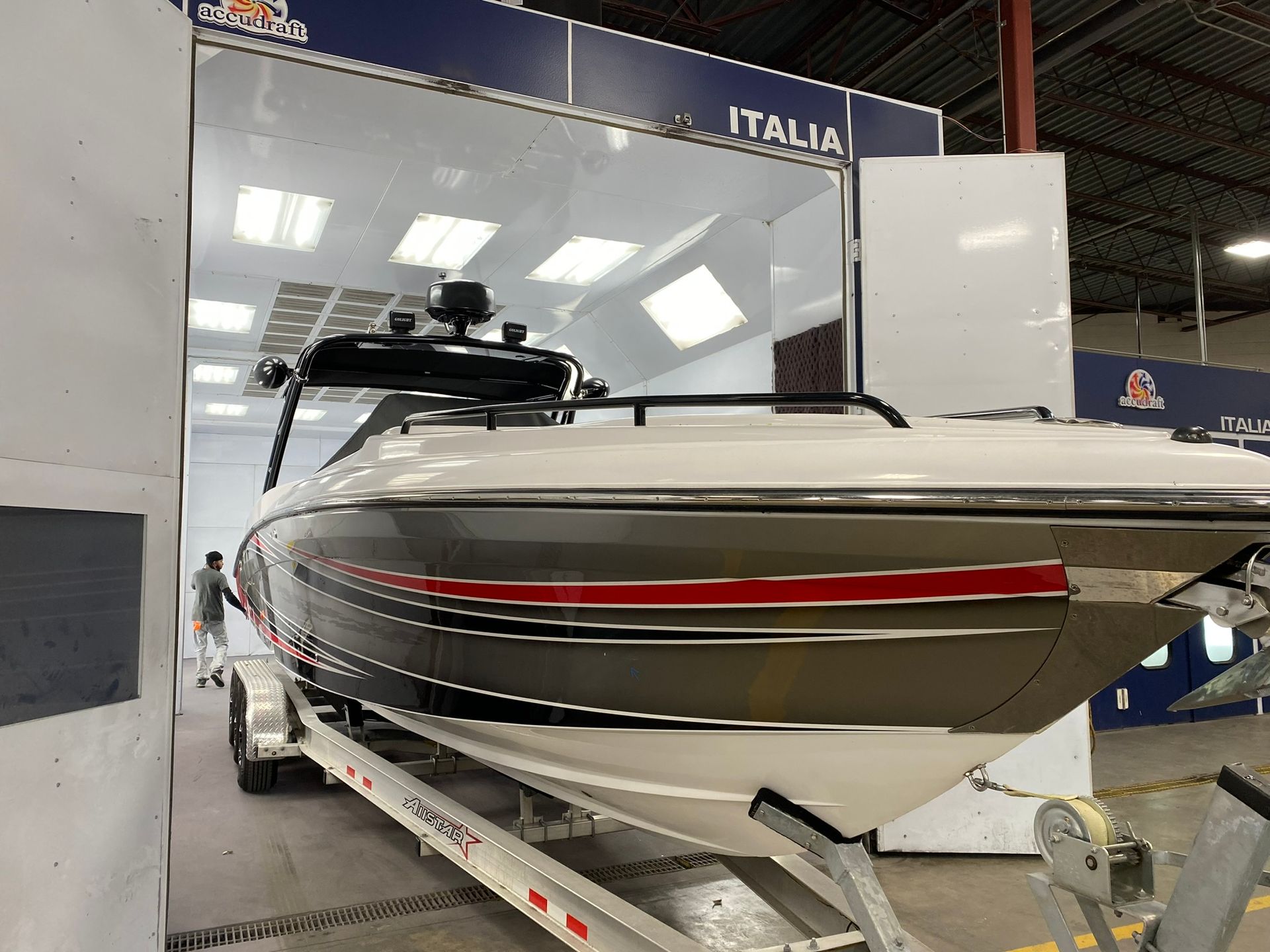 A boat is sitting on a trailer in a garage.