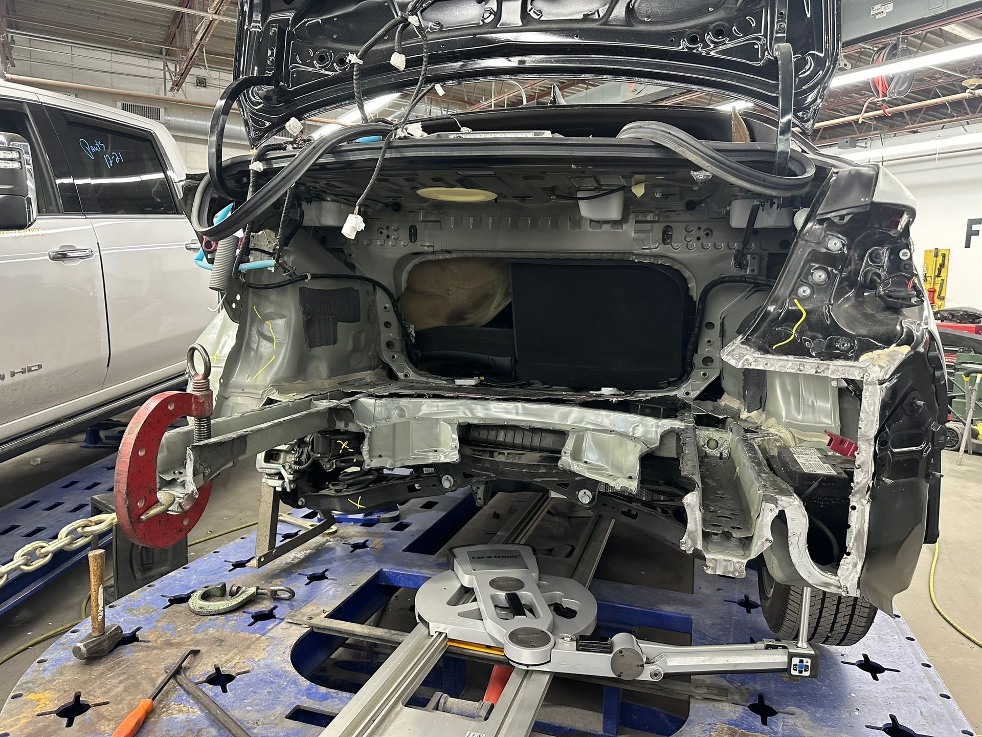A car is being worked on in a garage.