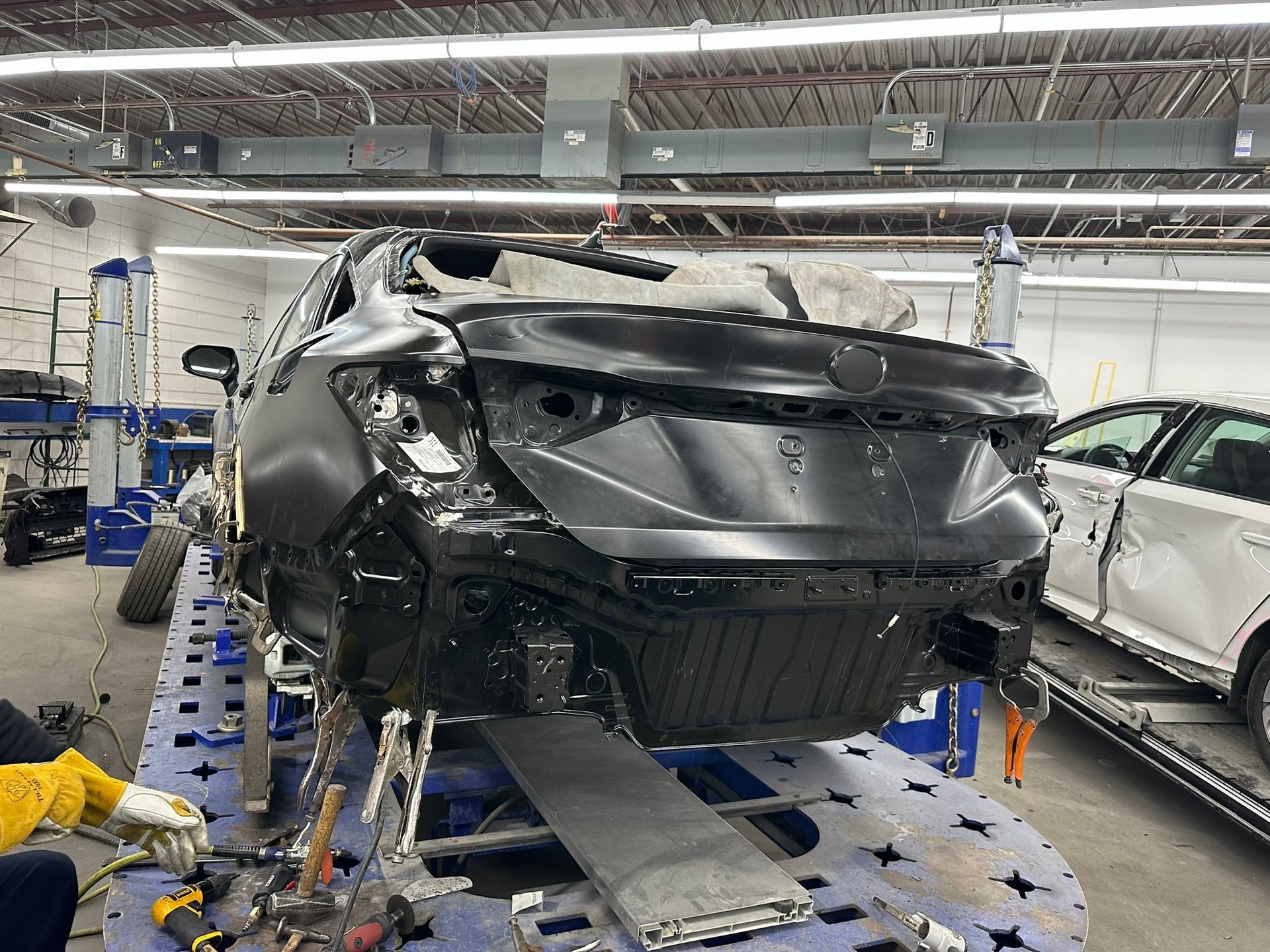 A car is being repaired in a garage.